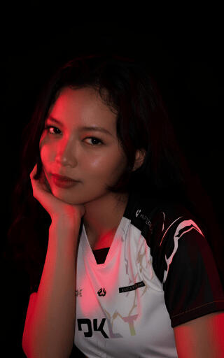 A portrait of HUNNY, Creative Operations Manager for DKLT Designs, wearing an E-sports jersey.